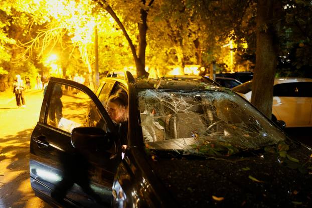 Firefighters work at the site of an apartment building hit by a Russian missile strike in Kyiv