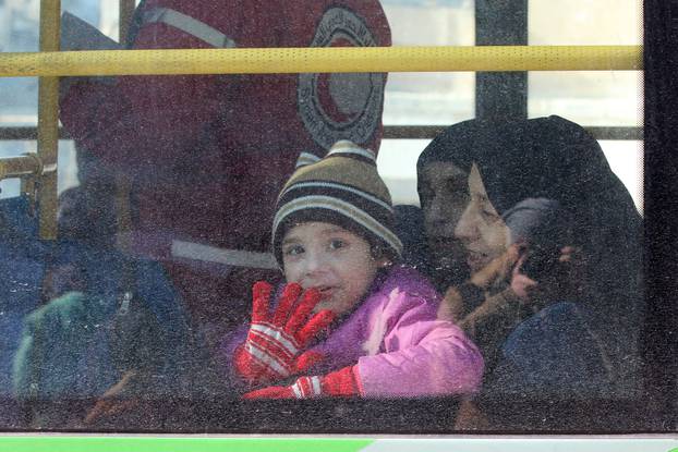 A child reacts from inside a bus evacuating people from a rebel-held sector of eastern Aleppo