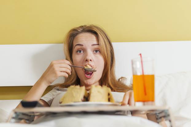 Day gluttony, teen girl eating a cake and drinks soda