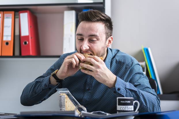 hungry man eating a sandwich