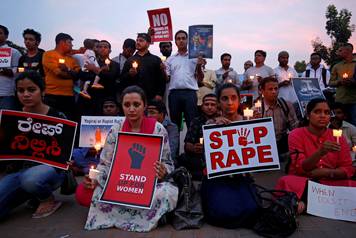 FILE PHOTO: People participate in a candle light vigil as they protest against the rape of an eight-year-old girl in Kathua near Jammu, and a teenager in Unnao, Uttar Pradesh state, in Bengaluru