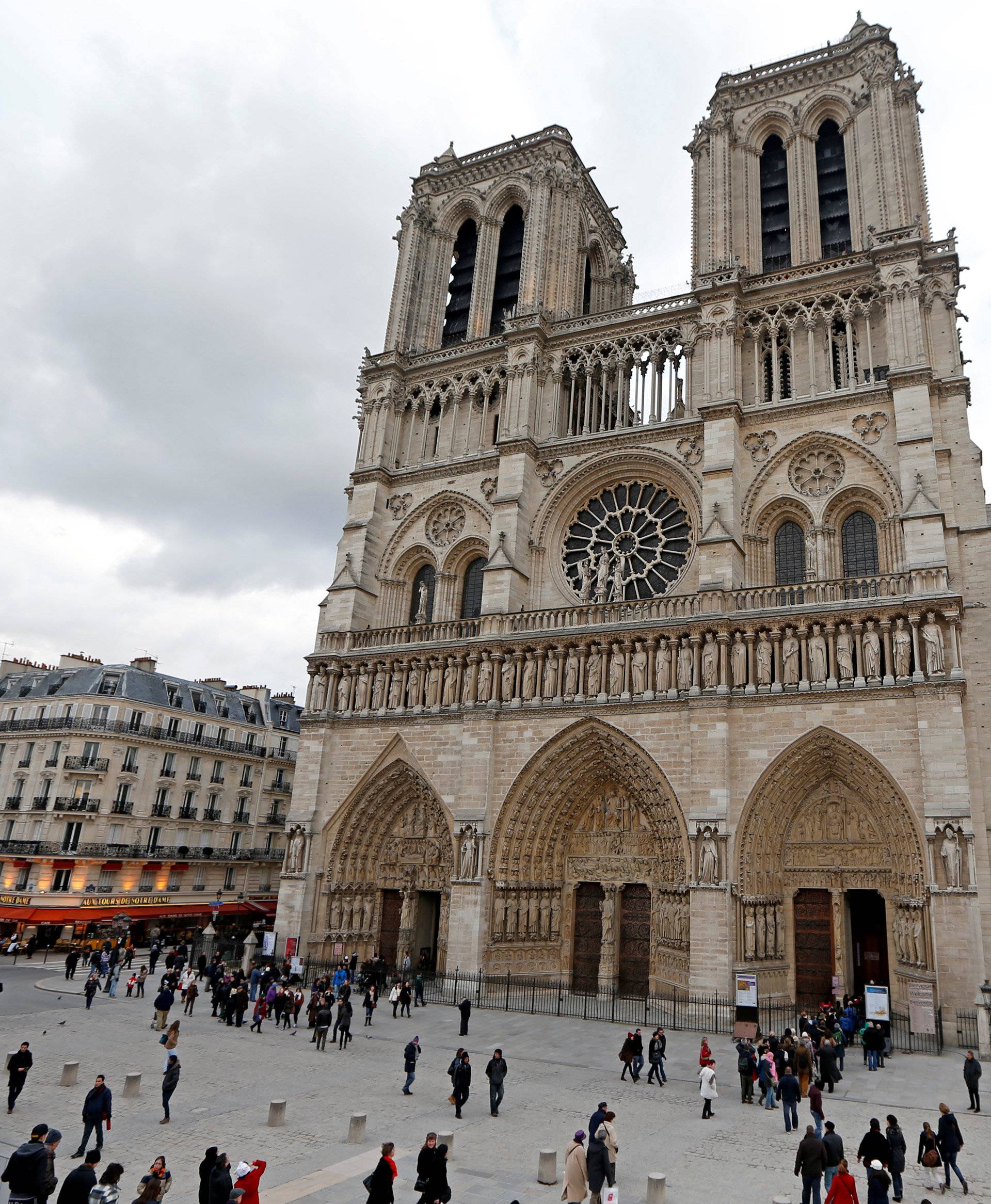 FILE PHOTO: People walk past the entrance to the Notre Dame Cathedral in Paris