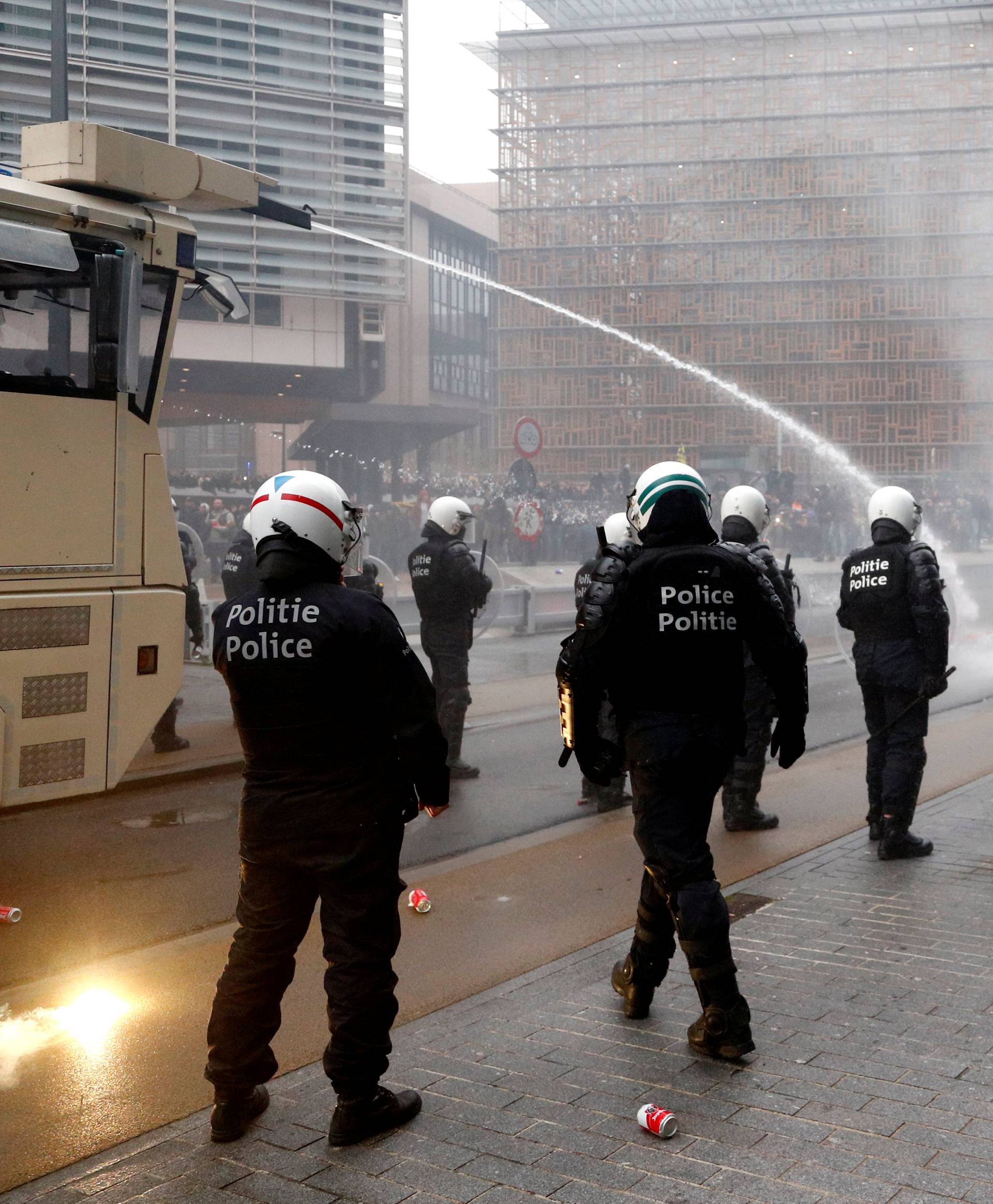 Police officers use a water cannon during a protest against Marrakesh Migration Pact in Brussels