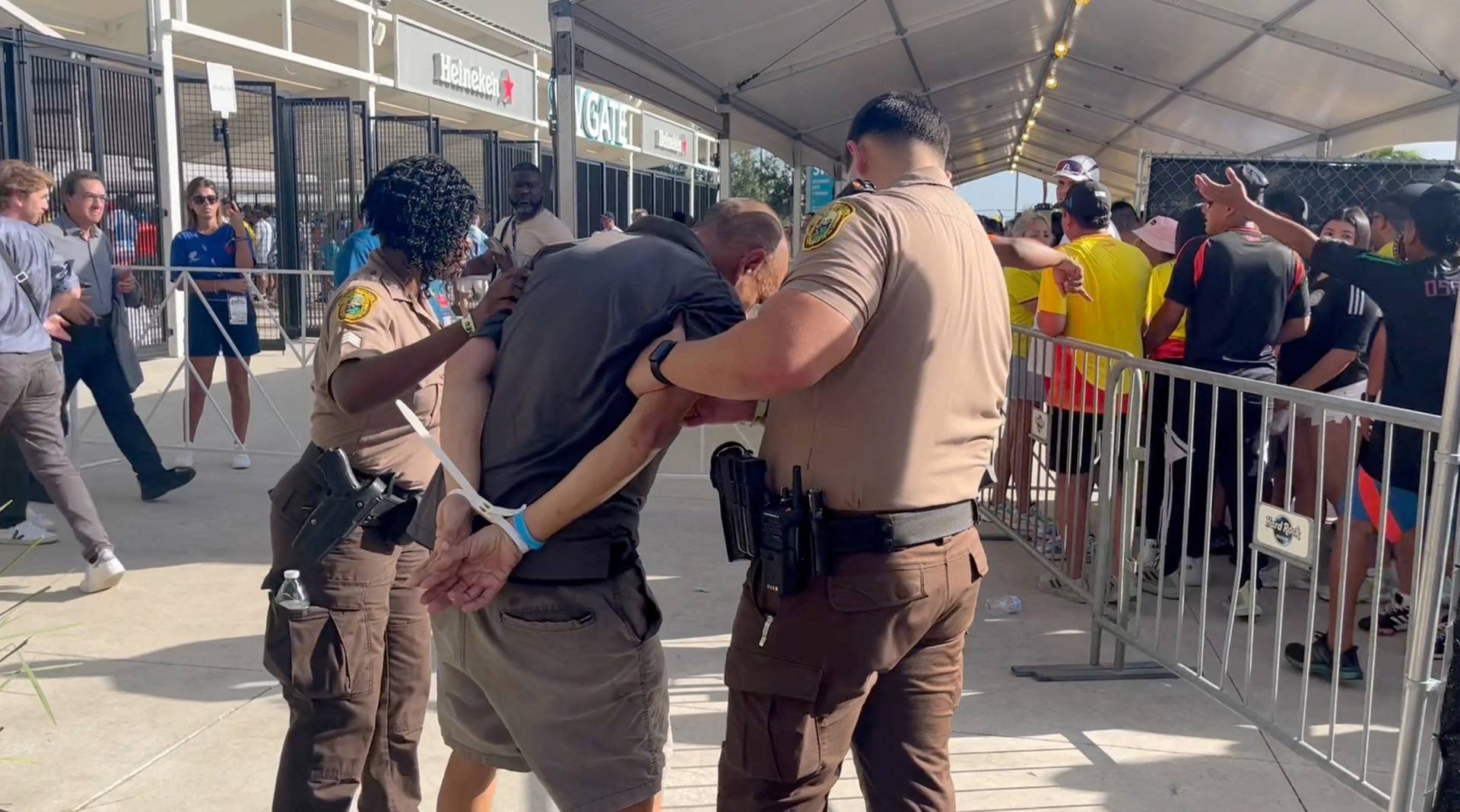 A man is detained by the police at Hard Rock Stadium, in Miami