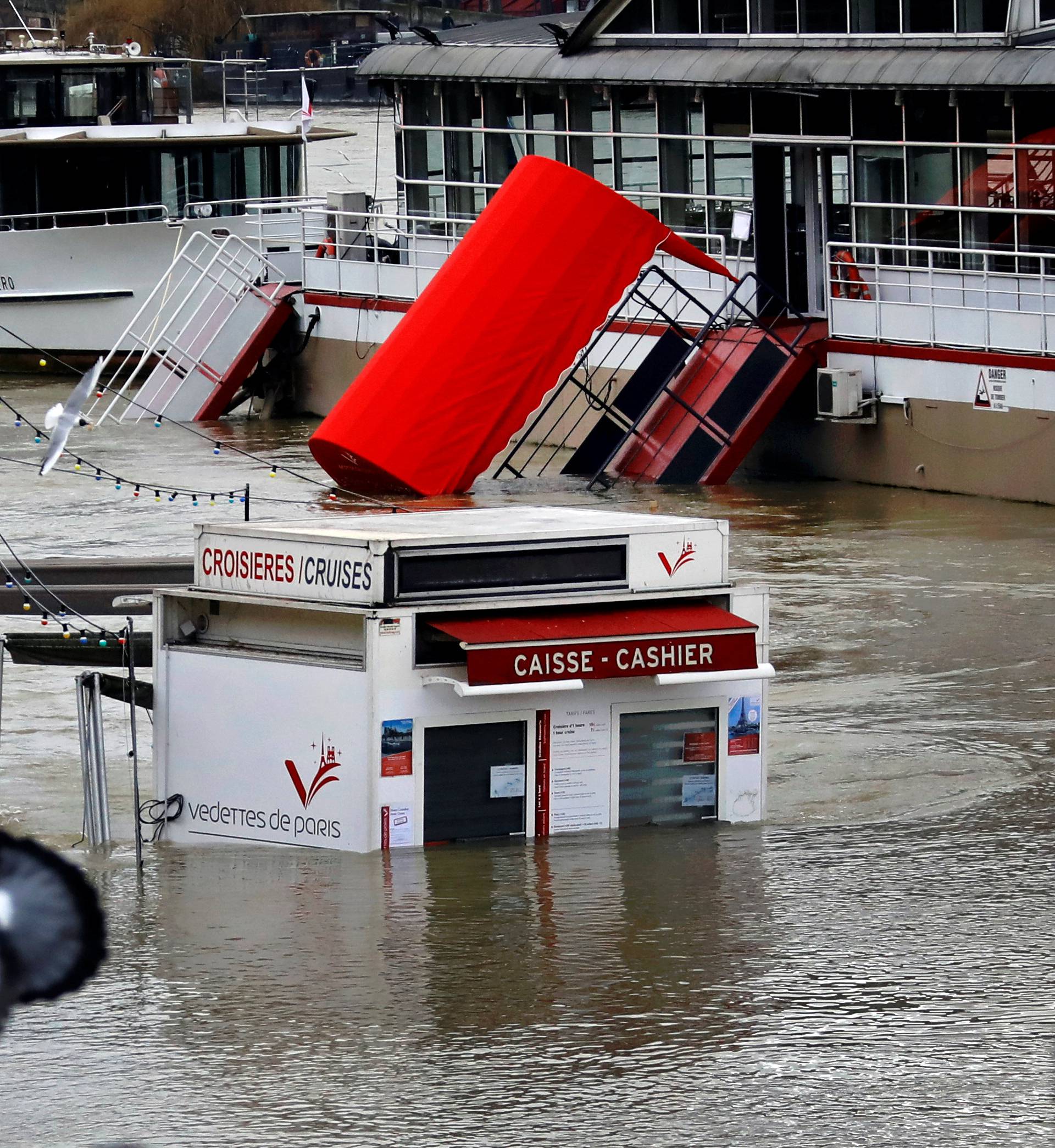 A ticket booth for sightseeing boats is partly submerged by the River Seine in Paris
