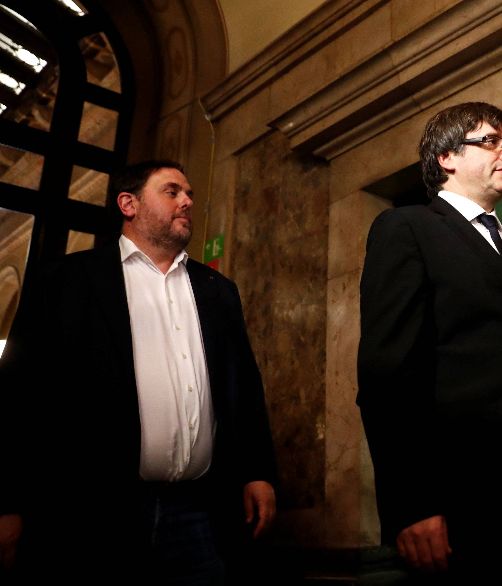 Catalan President Carles Puigdemont walks to the chamber at the Catalonian regional parliament in Barcelona