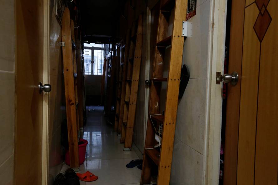 A corridor with ladders is seen inside a flat filled with partitioned units, or "coffin units", in Hong Kong