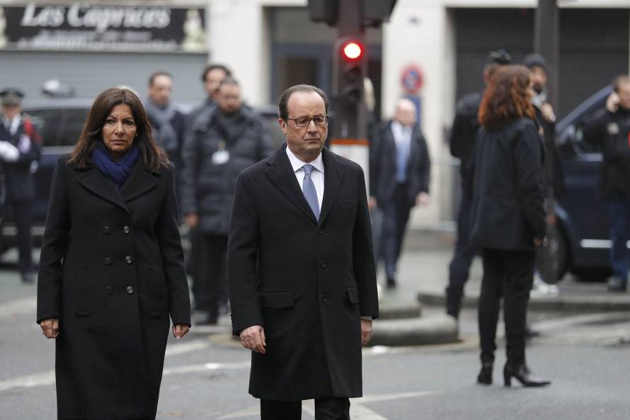 French President Francois Hollande and Paris Mayor Anne Hidalgo unveil a commemorative plaque next to the "La Belle Equipe" bar and restaurant in Paris