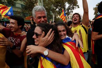 People celebrate after the Catalan regional parliament declares the independence from Spain in Barcelona