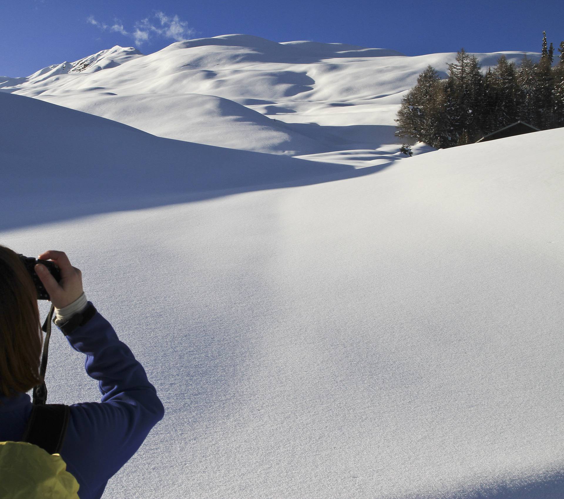 Tourist takes photos of snowy landscape