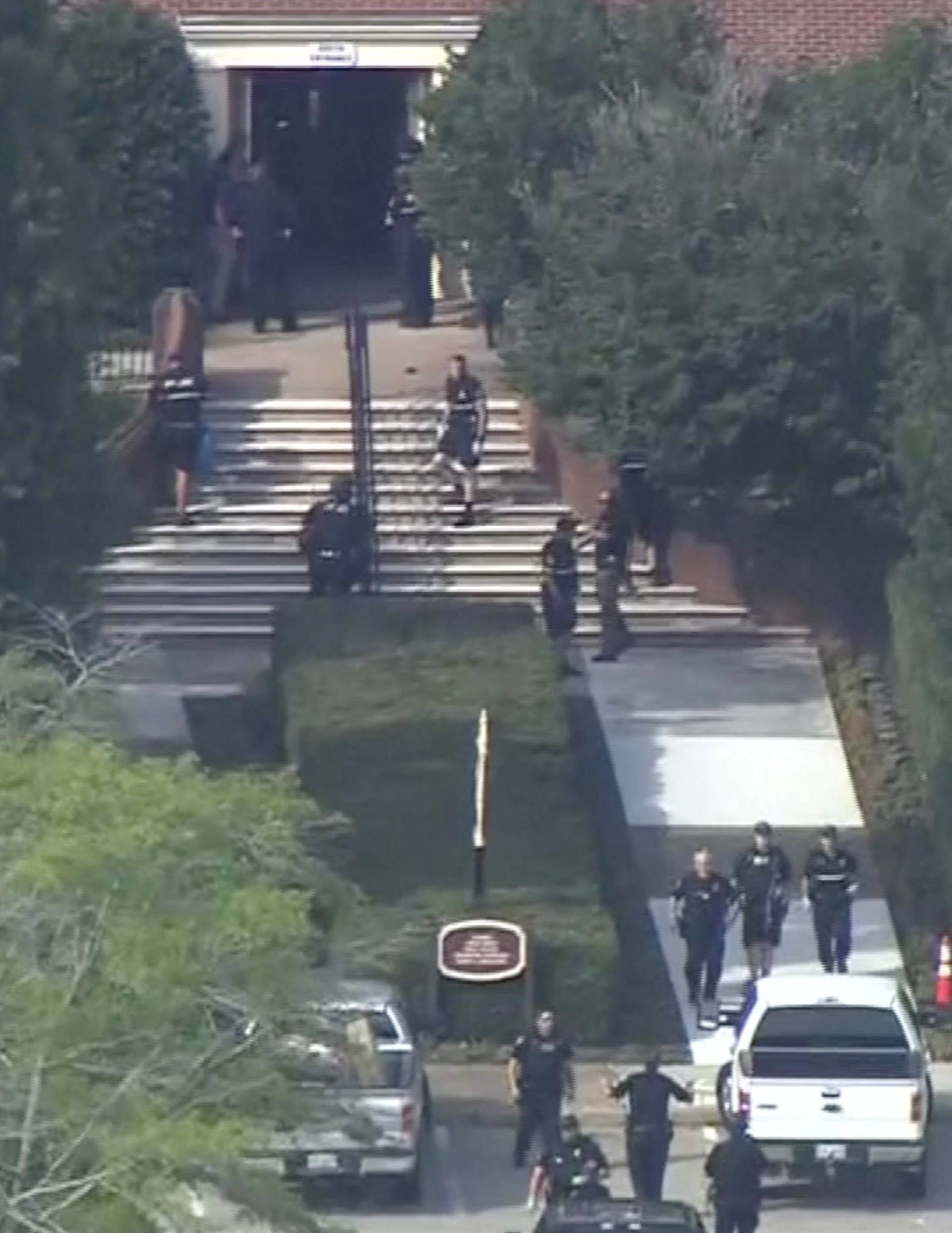 Police evacuate people from a building as a stretcher stands by in this still image taken from video following a shooting incident at the municipal center in Virginia Beach