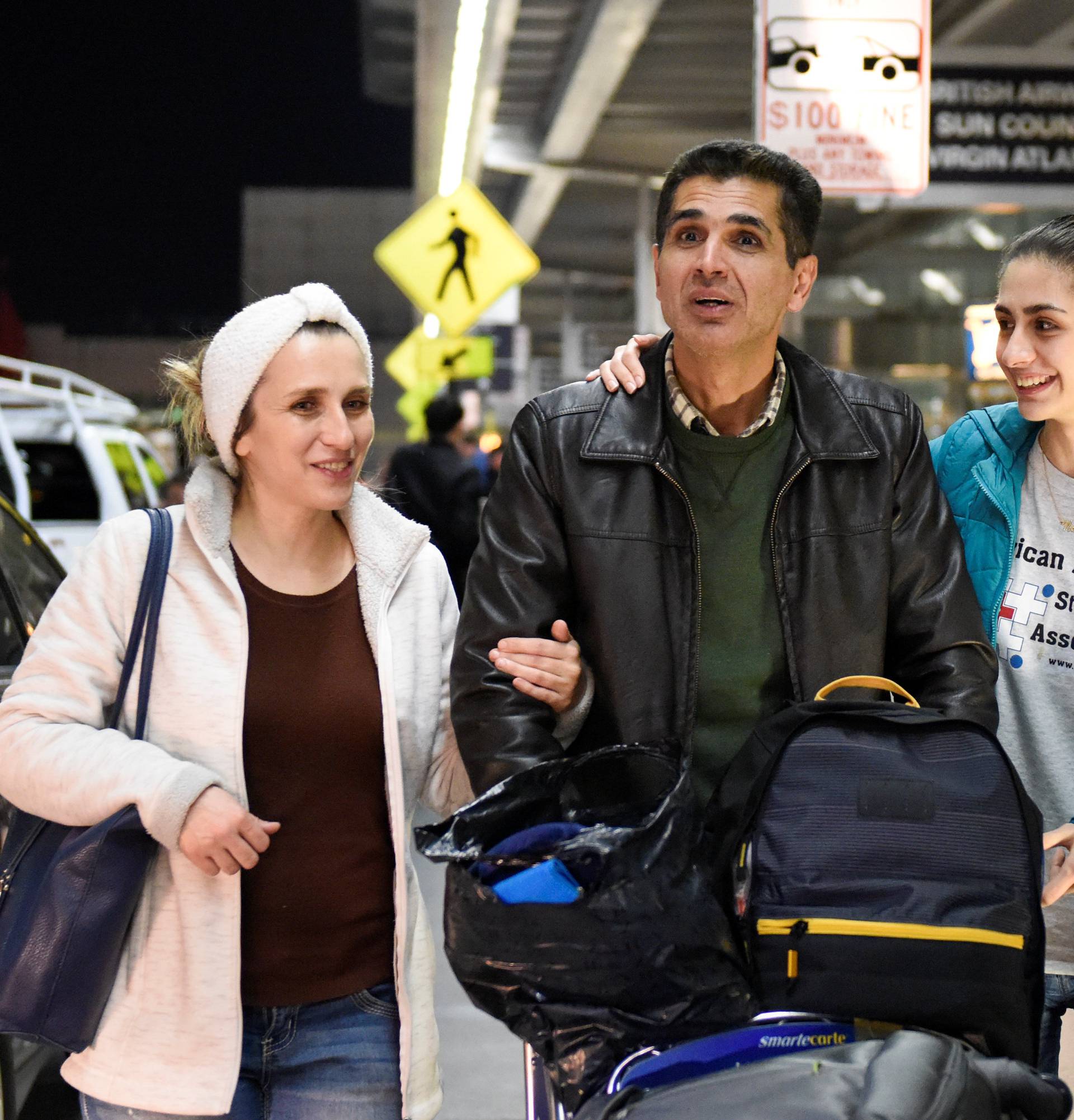 Medhi Radgoudarzi leaving the airport with his wife and daughter after being detained for five hours due to new immigration laws at San Francisco International Airport in San Francisco