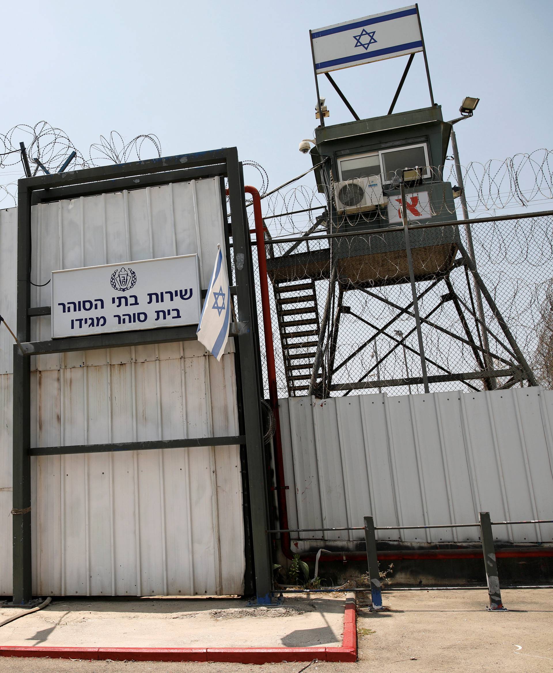An Israeli flag is seen next to the gate of the Megiddo Prison