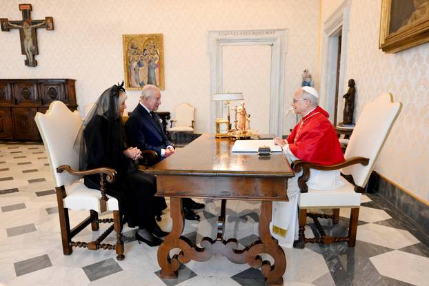 Pope Leo XIV meets with Britain's King Charles and Queen Camilla during a private audience at the Vatican