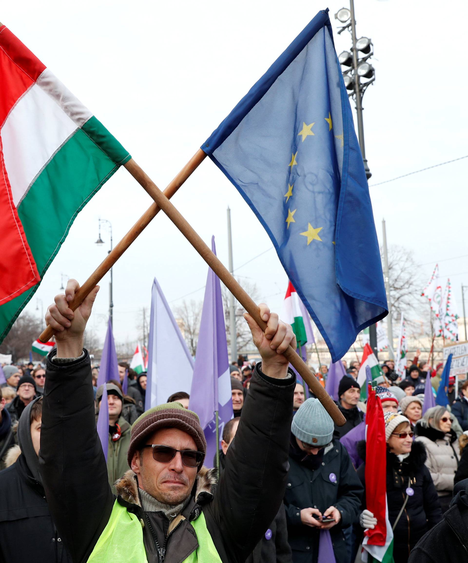 People take part in a protest against a proposed new labor law, billed as the "slave law", in Budapest