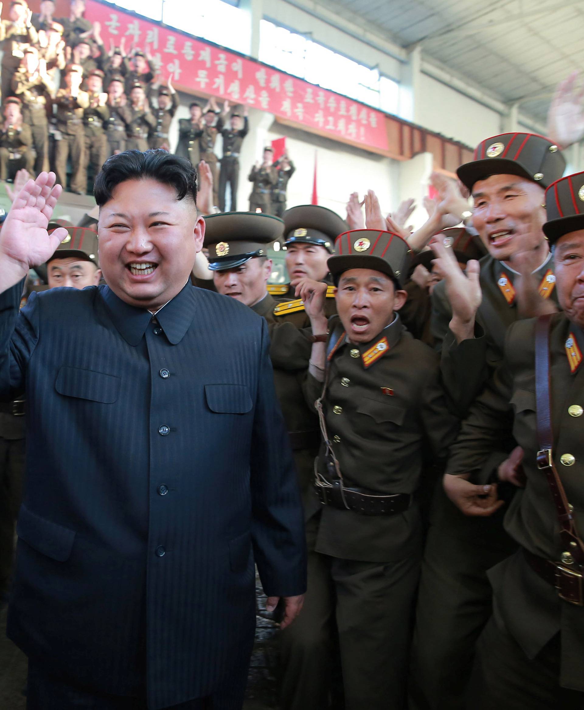 North Korean leader Kim Jong Un reacts with members of the Korean People's Army