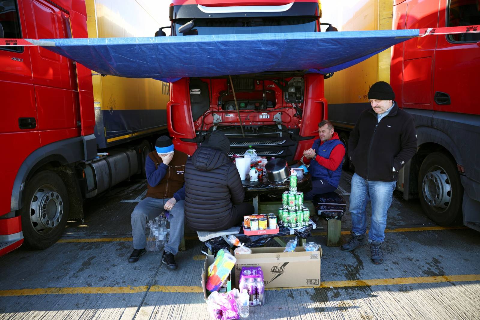 Lorry drivers from Poland sit around a table at a service station on the outskirts of Dover