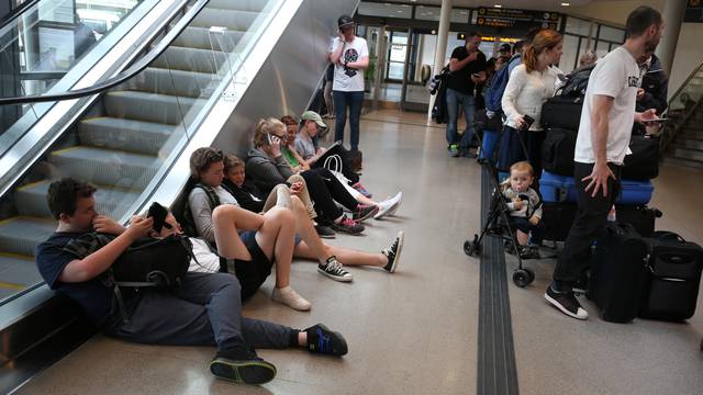 Passengers wait for flight information at the domestic terminal of Arlanda airport in Stockholm