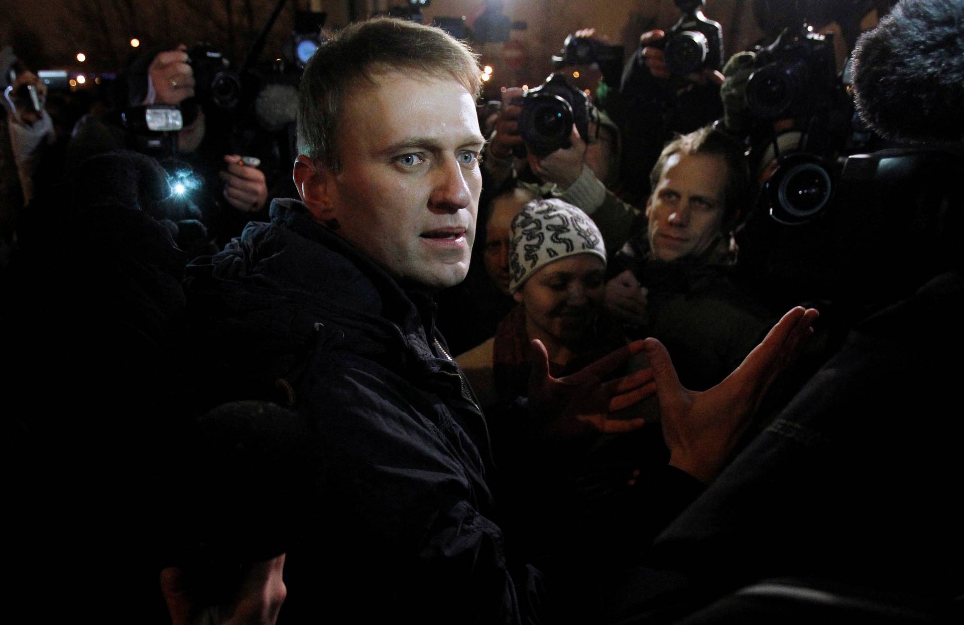 FILE PHOTO: Anti-corruption blogger Alexei Navalny speaks with journalists as he leaves a police station on the day of his discharge in Moscow