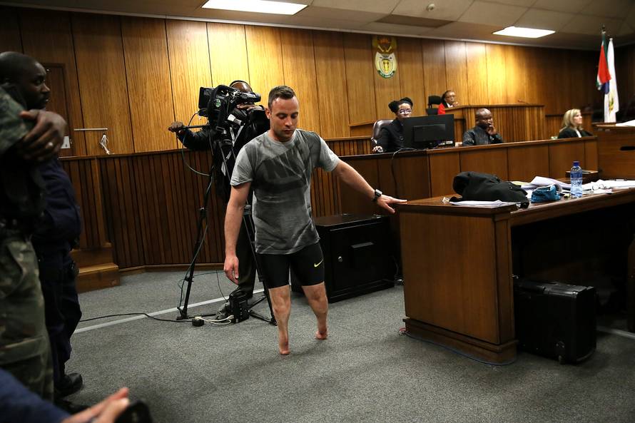 Paralympic gold medalist Oscar Pistorius walks across the courtroom without his prosthetic legs during the third day of his resentencing hearing for the 2013 murder of his girlfriend Reeva Steenkamp