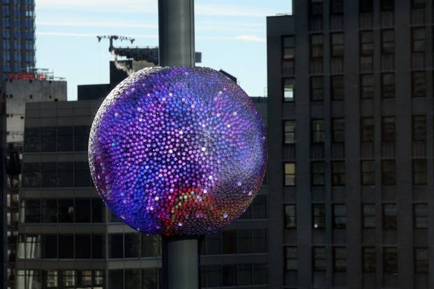 A newly created New Year's eve ball adorned with 5,280 Waterford crystals is raised for the first time above One Times Square ahead of the New Year's Eve ball drop in New York City