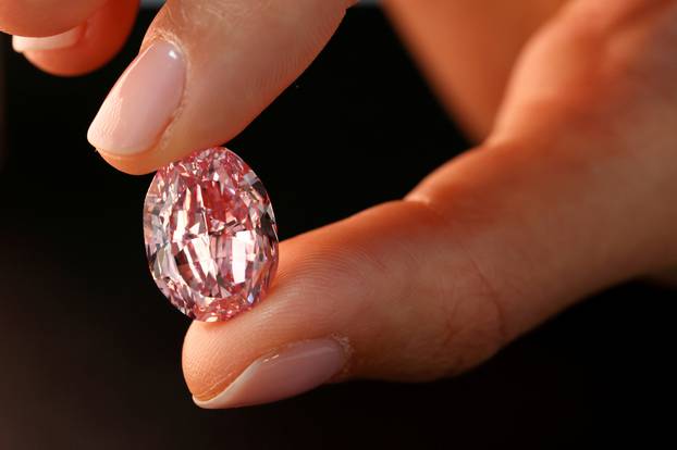 FILE PHOTO: A model poses with "The Spirit of the Rose" purple-pink diamond in Geneva