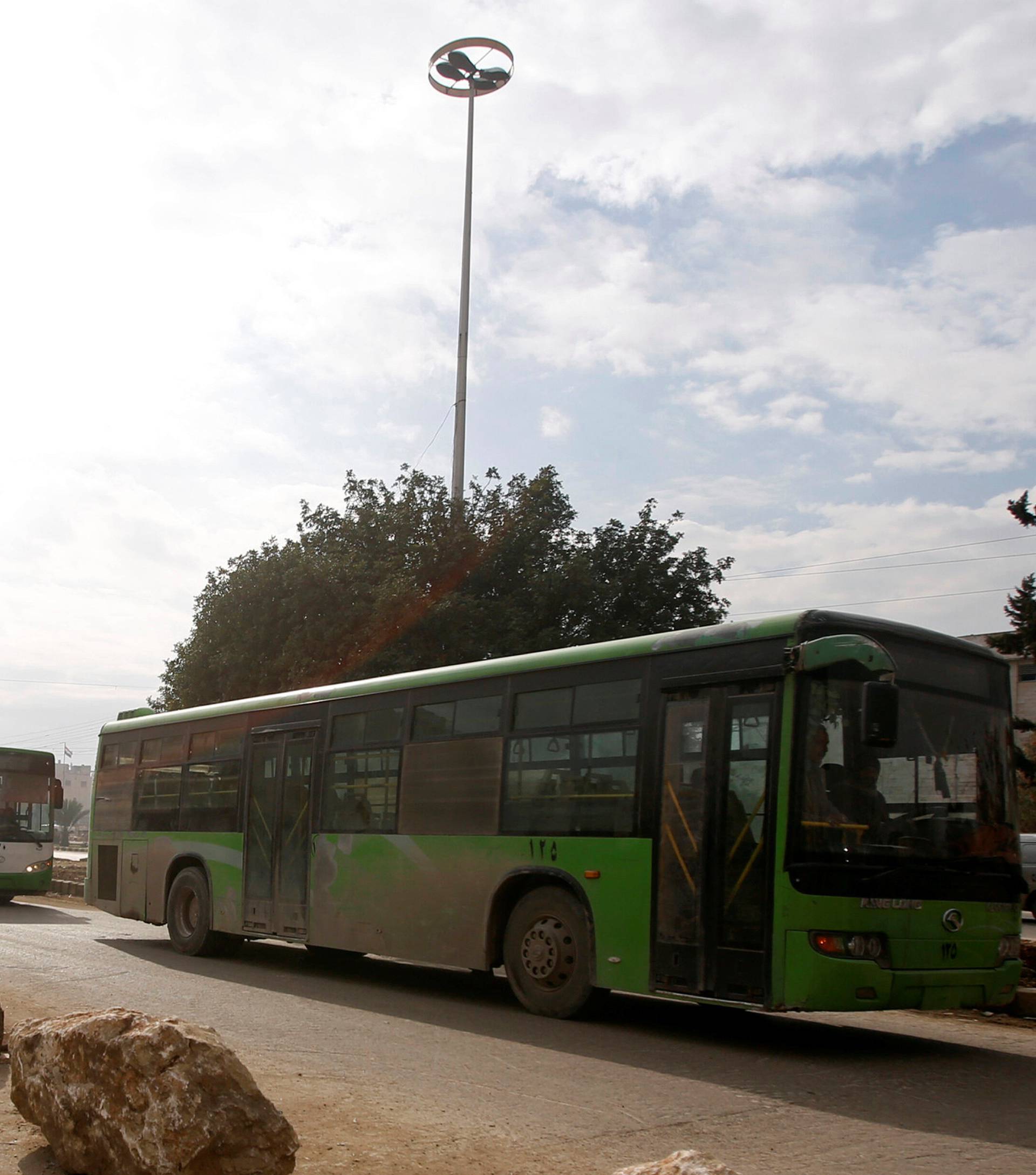 Empty buses are seen leaving after the evacuation of people from eastern Aleppo was suspended