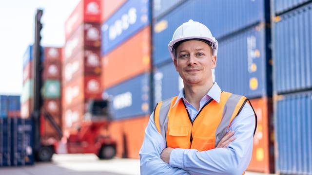 Portrait,Of,Caucasian,Engineer,Worker,Work,In,Container,Port,Terminal.