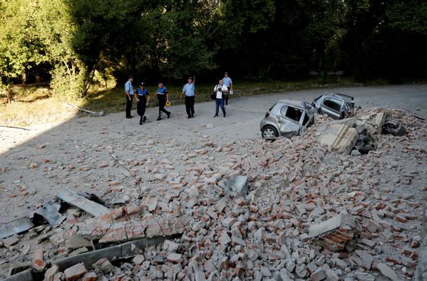Destroyed cars and a pile of rubble from a damaged building are seen after an earthquake in Tirana