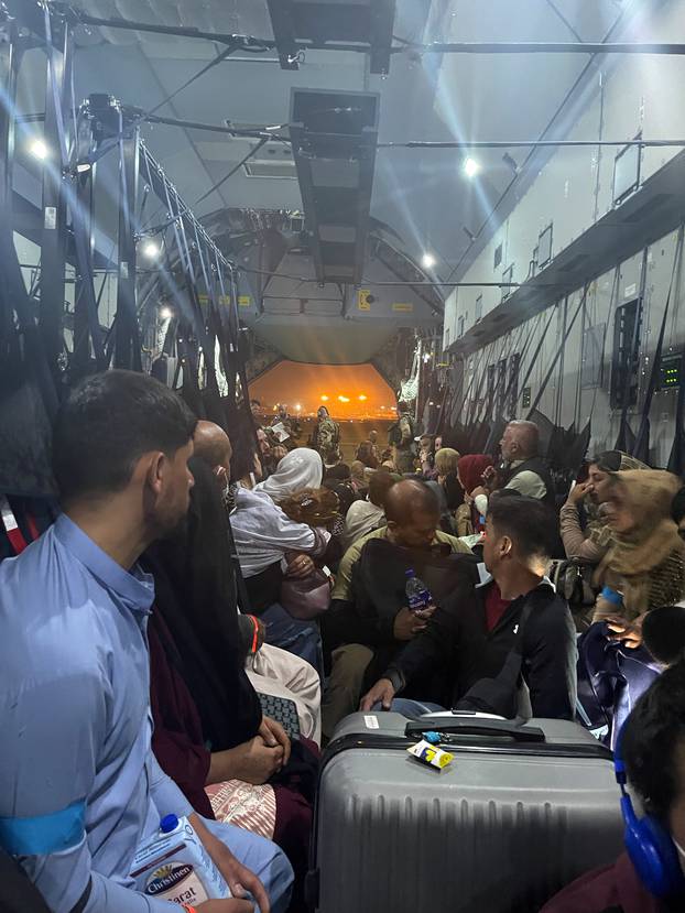 Evacuees from Afghanistan sit inside an aircraft of the German Air Force Luftwaffe in Kabul