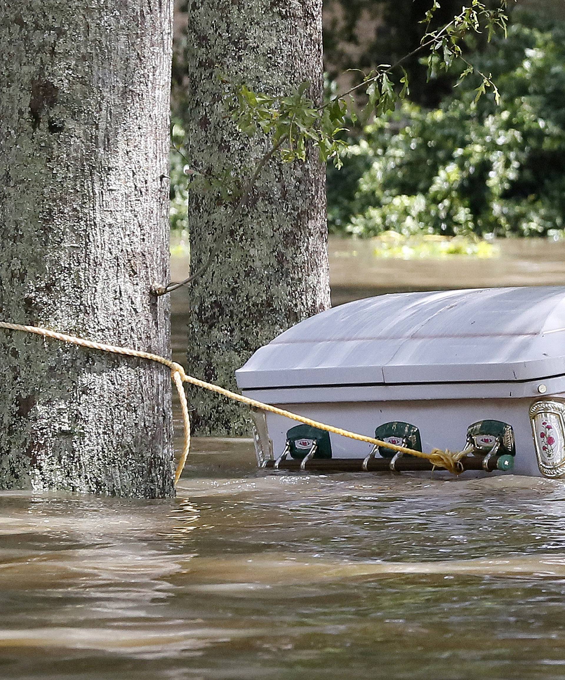 A casket is seen floating in flood waters in Ascension Parish