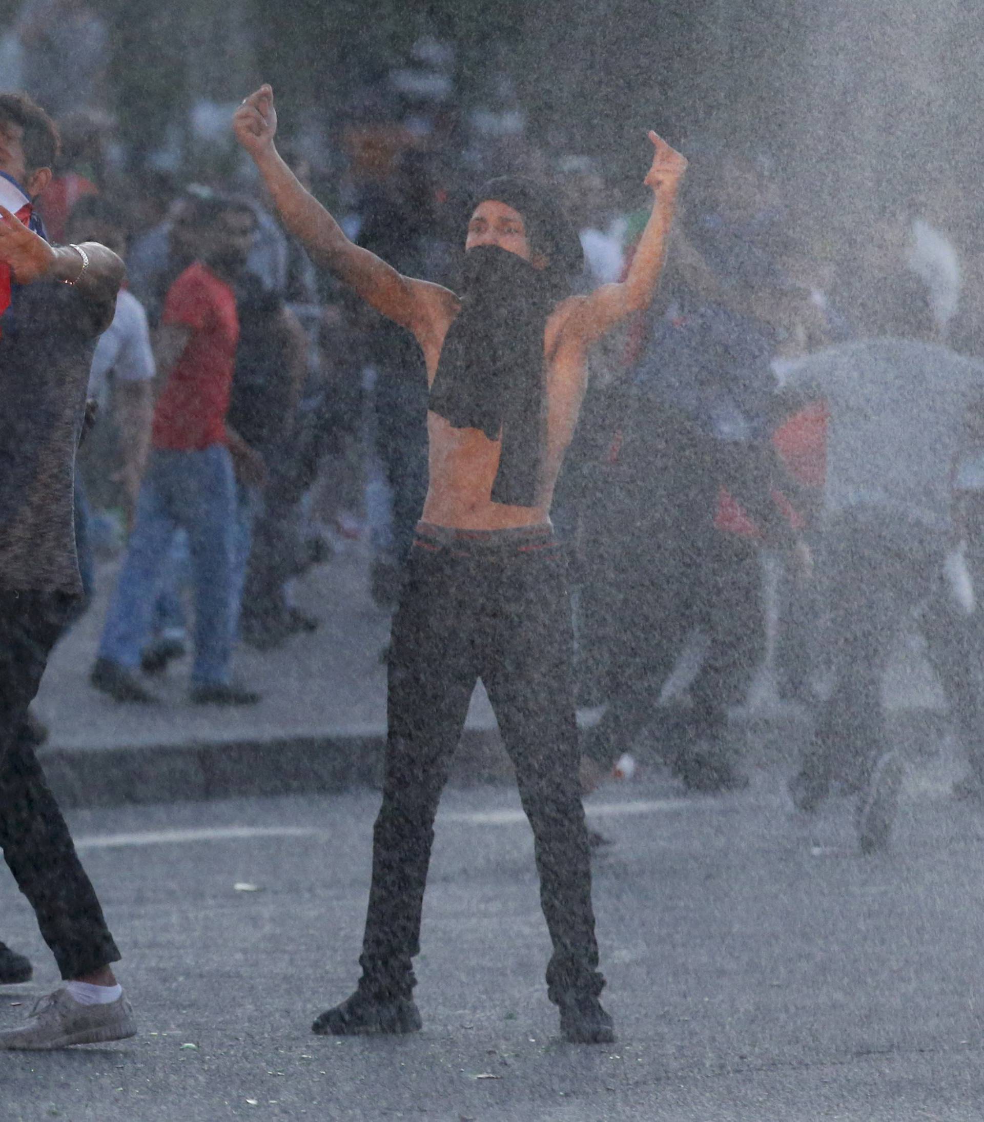 Youths taunt French riot police during clashes outside the Paris fan zone during a EURO 2016 final soccer match       