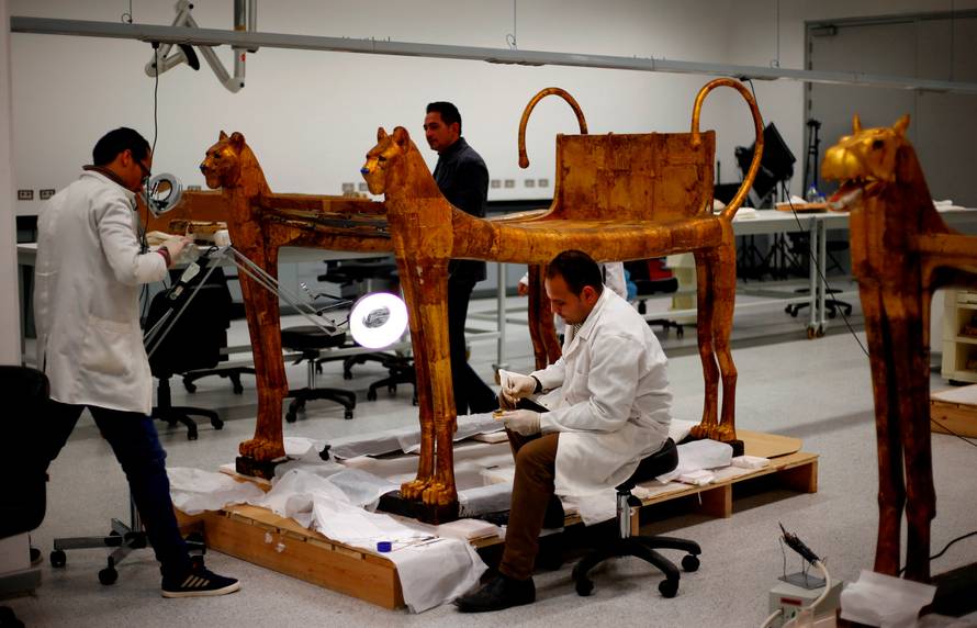 General manager of technical affairs Hussien Kamal looks on as the archaeological technicians work on the artefacts which belonged to The Golden King Tutankhamun, in the conservation centre of the Grand Egyptian Museum, on the outskirts of Cairo