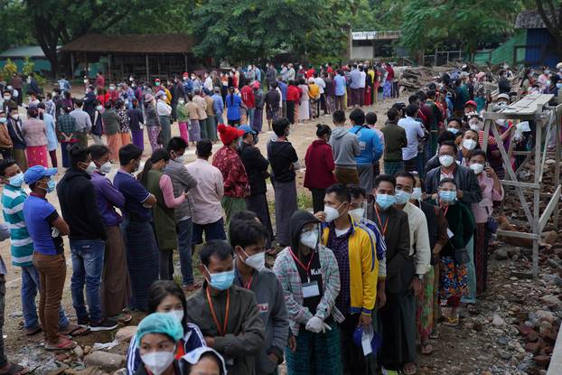 Poeple wait in line before voting during the general election at a polling station in Kachin State, Myanmar
