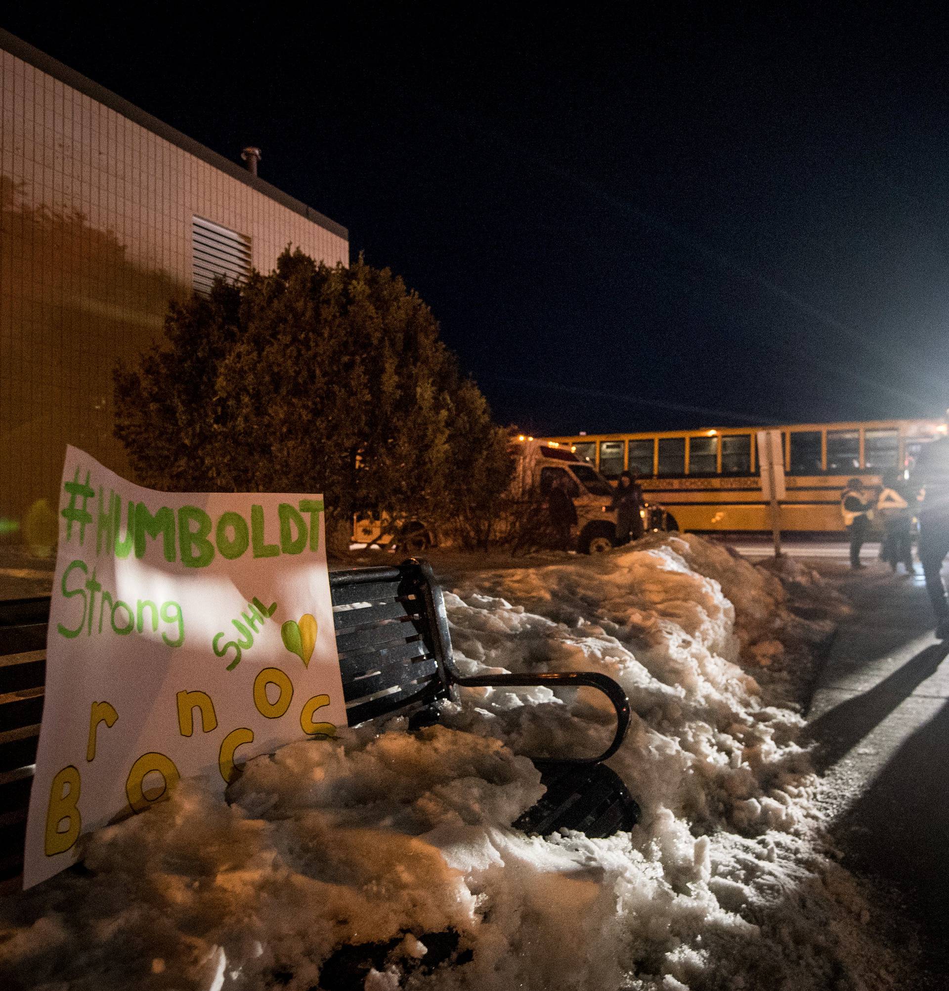 A sign showing support for the victims and families of a fatal bus crash is on display as members of the community leave a vigil for the Humboldt Broncos