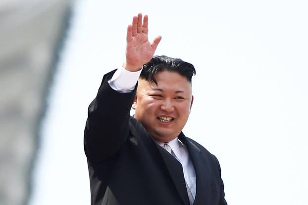 FILE PHOTO:North Korean leader Kim Jong Un waves to people attending a military parade marking the 105th birth anniversary of country