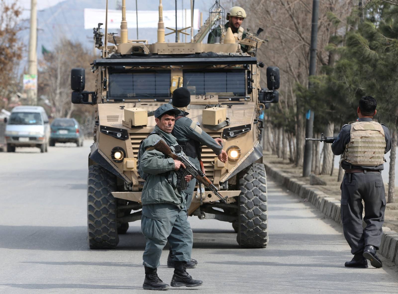 Afghan police officers keep watch near the site of an attack in Kabul