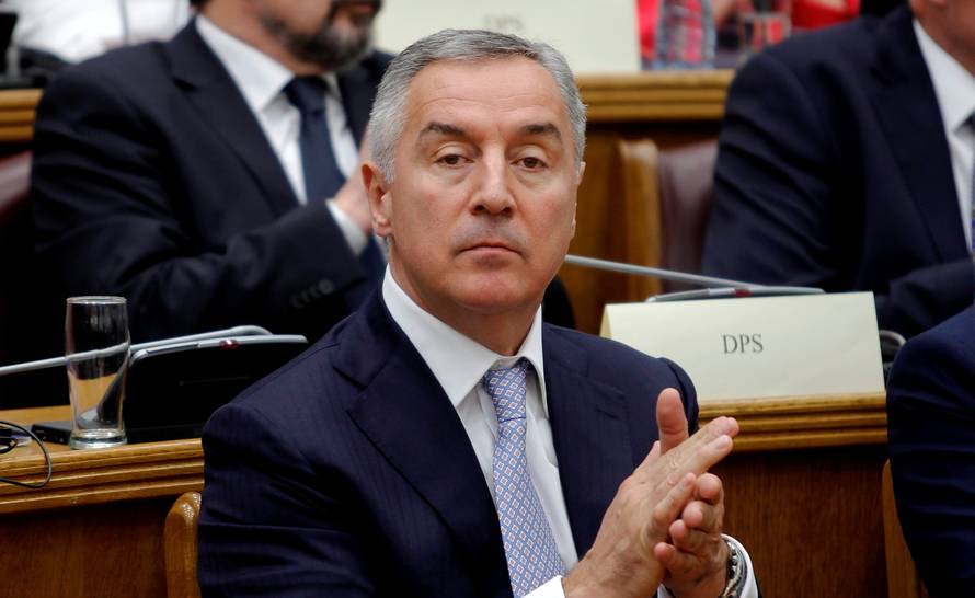 President of a ruling Democratic Party of Socialist (DPS), former prime minister and president of Montenegro, Milo Djukanovic applauds during a parliament discussion on NATO membership agreement in Cetinje