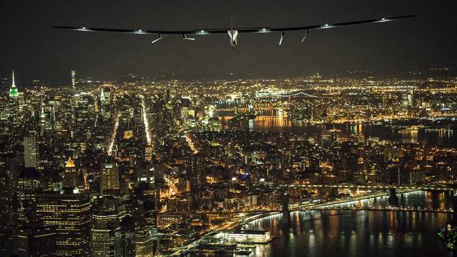 Solar Impulse 2, the solar airplane, piloted by Swiss adventurer Andre Borschberg, flies over Manhattan shortly before landing at John F. Kennedy airport