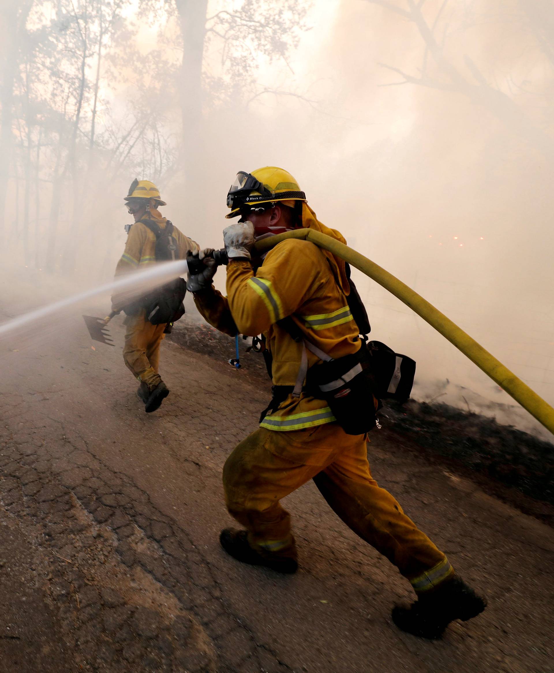 FILE PHOTO: Firefighter knocks down hotspots to slow the spread of the River Fire in Lakeport