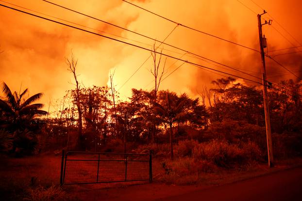 Lava illuminates the sky above Leilani Estates