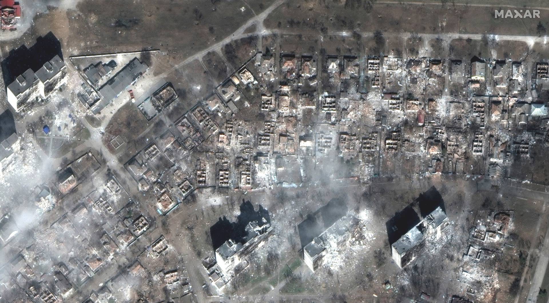 A satellite image shows apartment buildings and homes destroyed on east Mariupol