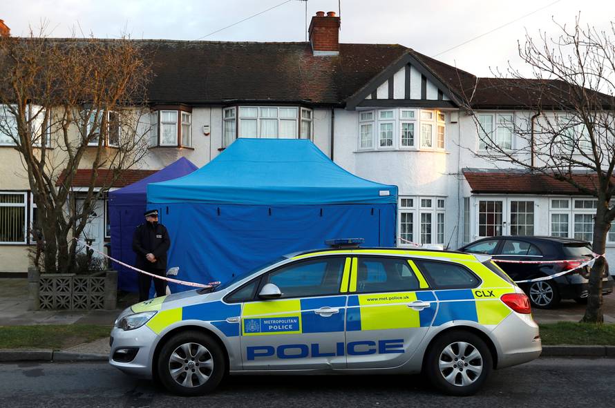 A police officer stands guard outside the home of Nikolai Glushkov in New Malden