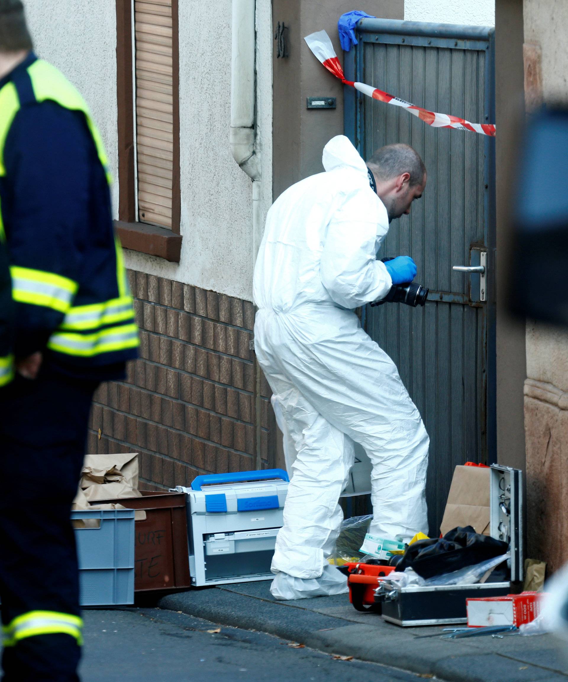 A forensic expert works at a crime scene where two people died during a police operation in Kirchheim