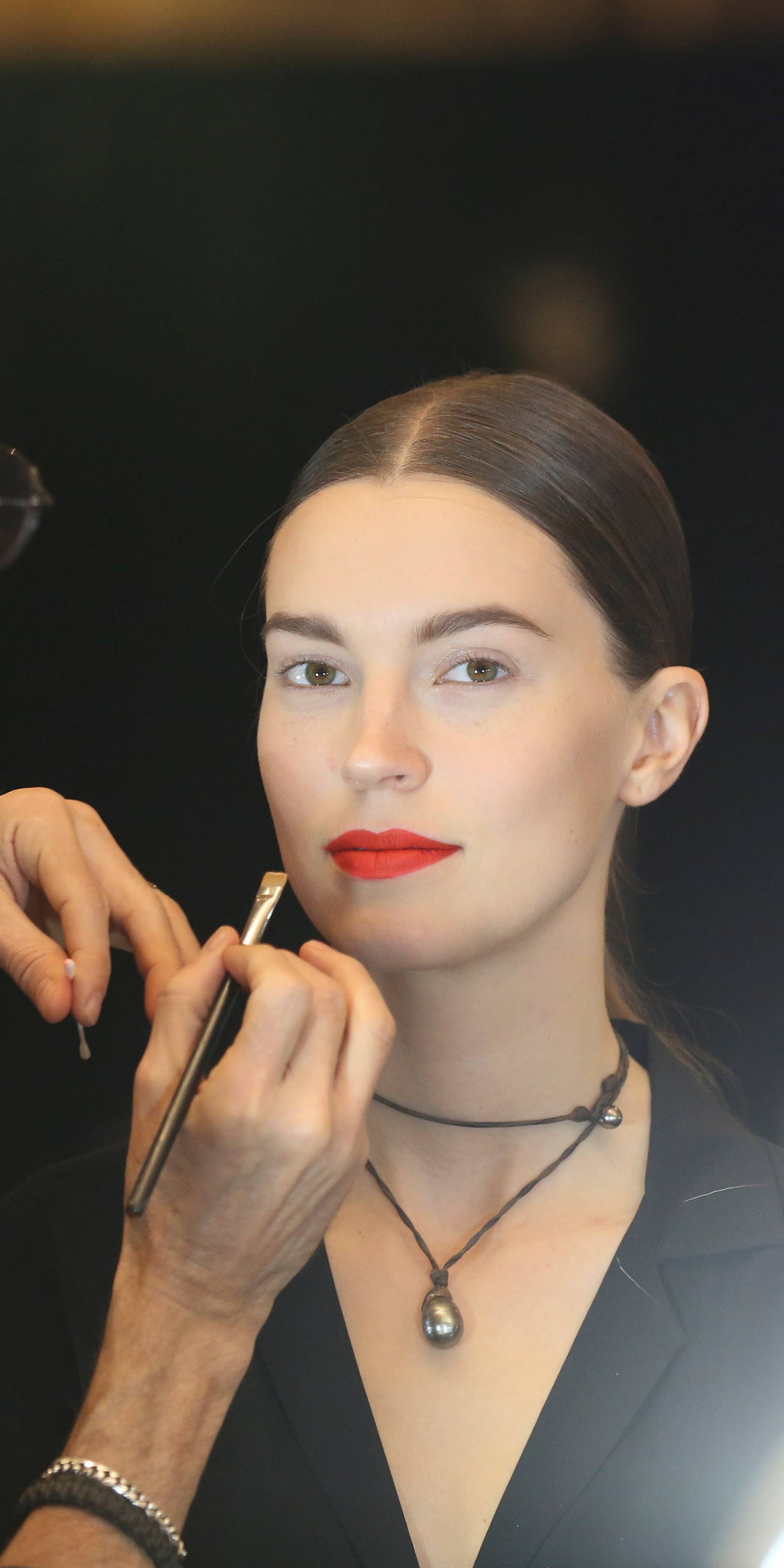 Models are prepped backstage before presenting creations from the Oscar de la Renta Fall 2020 collection during New York Fashion Week