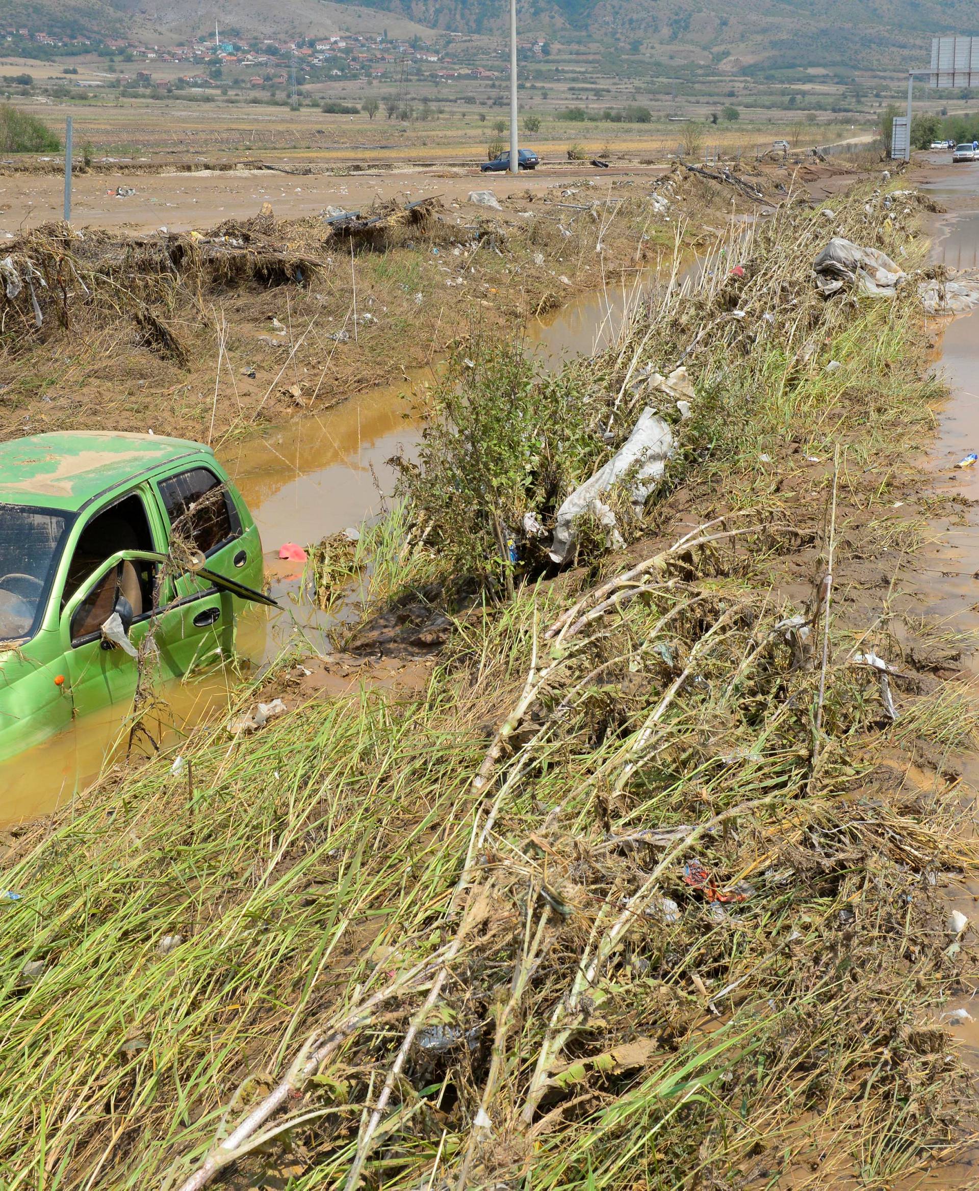 A wrecked car is seen after heavy floods in Cento 