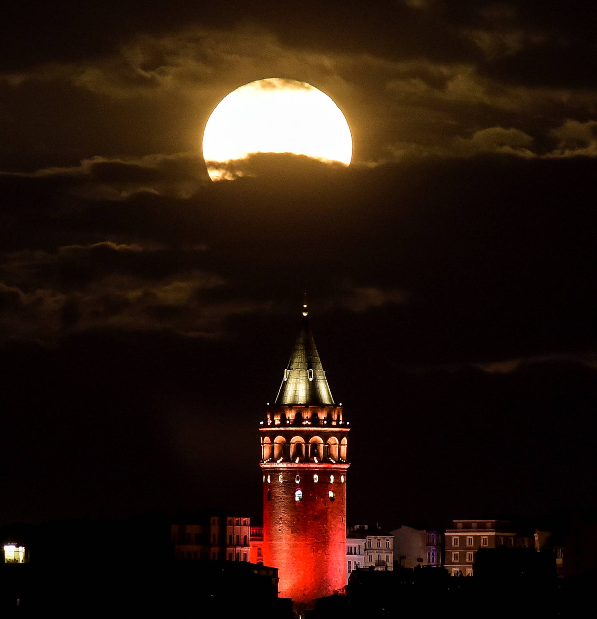 The supermoon is seen over the historical Galata Tower in Istanbul