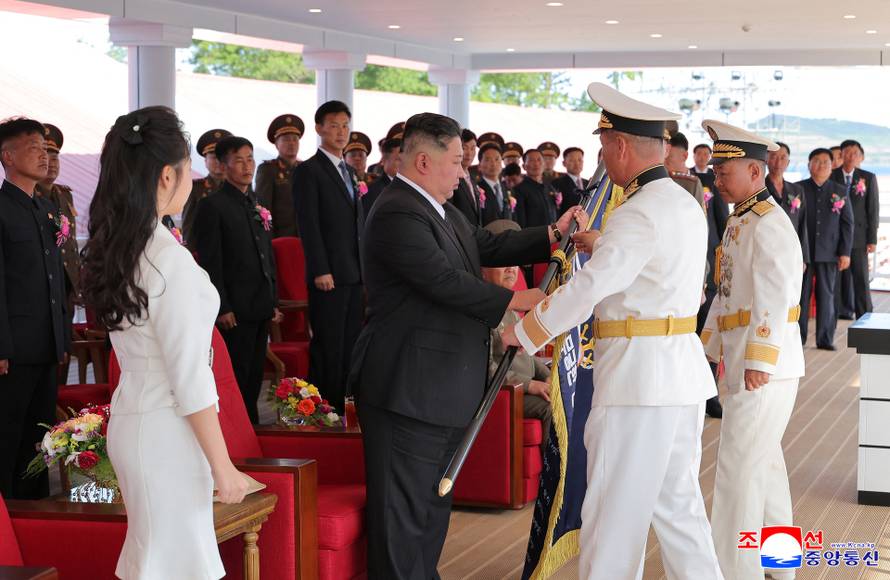 North Korean leader Kim Jong Un attends the launching ceremony of a warship that had been damaged upon its first attempt to launch