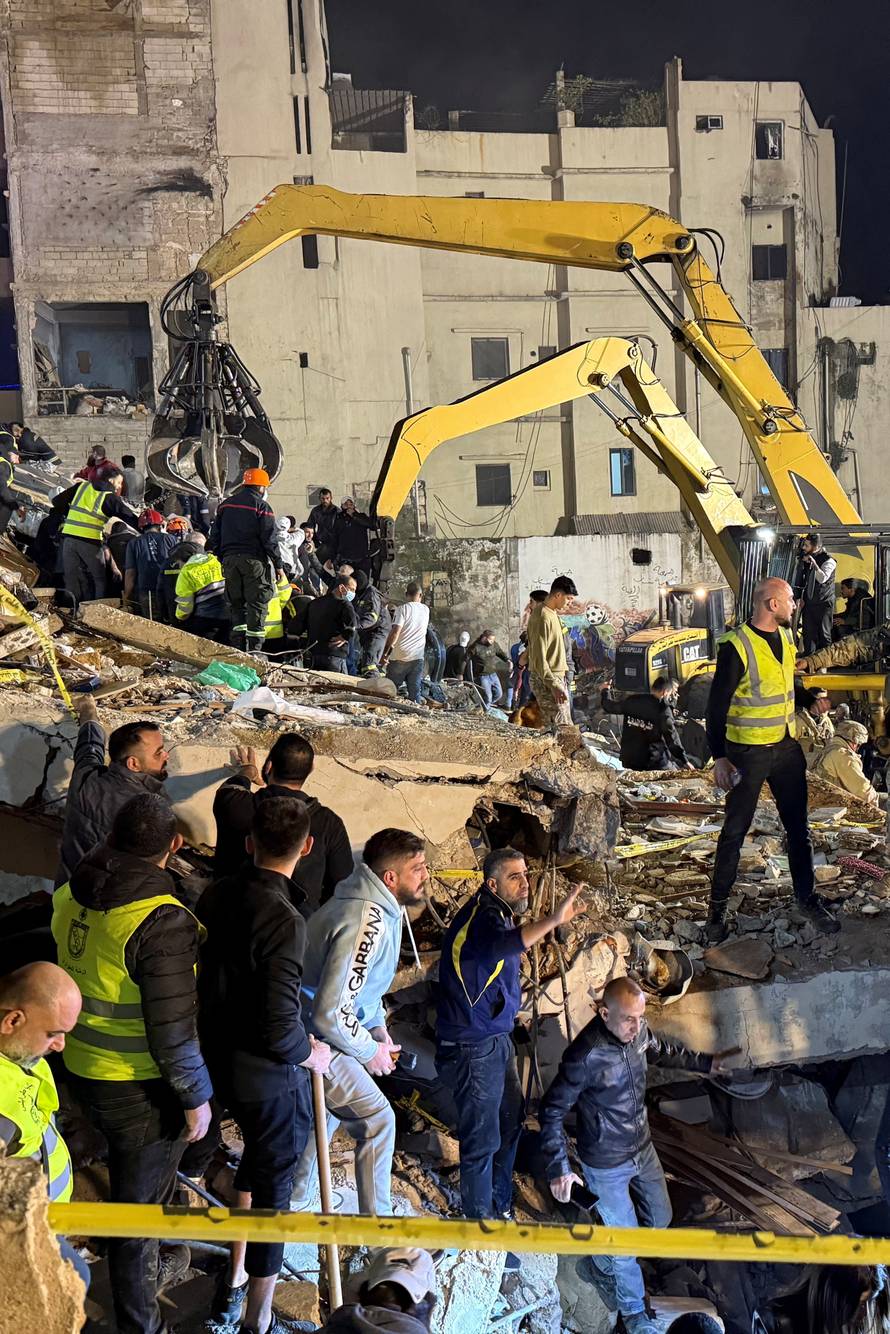 Rescue teams search for survivors after a building collapsed in Tripoli