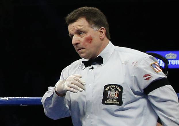 Referee Arthur Mercante Jr has blood on his cheek and shirt  after being hit by Badou Jack